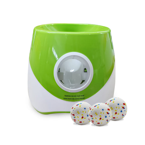 Green dog tennis ball launcher with three balls on a white background